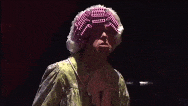 a man wearing a pink curlers on his head says `` you listen '' .