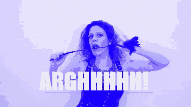 a woman is holding a whip in her mouth and the words arghhhhh are visible behind her