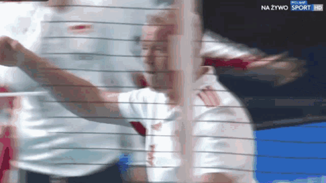 a blurred image of a man in a white shirt with the words na żywo sport hd on the bottom