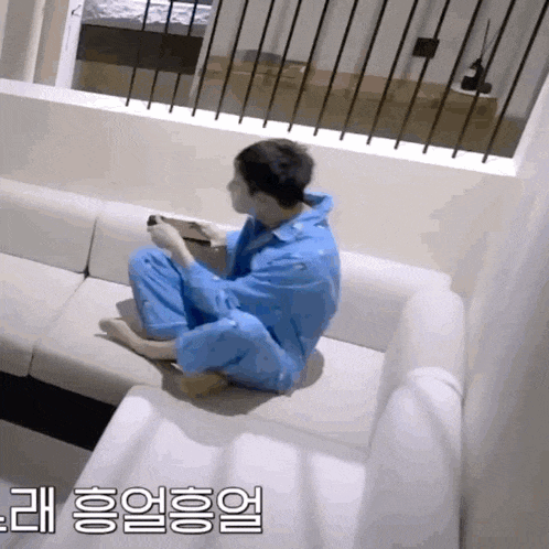 a man is sitting on a couch playing a video game