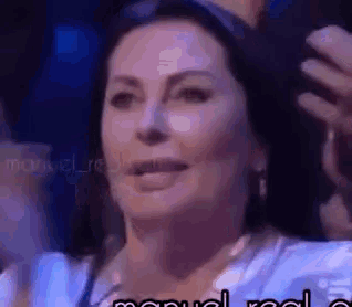 a close up of a woman 's face with the words " manuel real " on the bottom