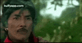 a man with a mustache is making a funny face in a movie .