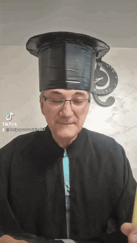 a man wearing a graduation cap and gown has tiktok written on the bottom