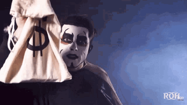 a person with a dollar sign on their face holds a bag