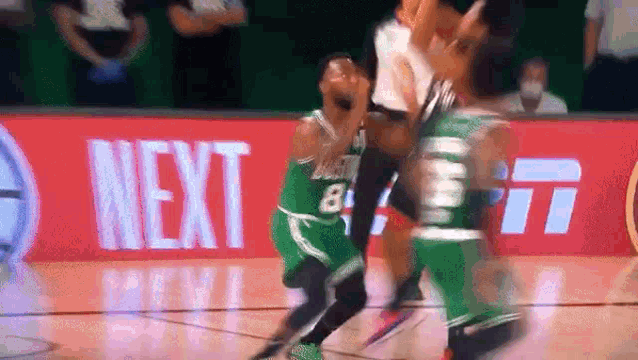 a basketball game is being played on a court with a sign that says next