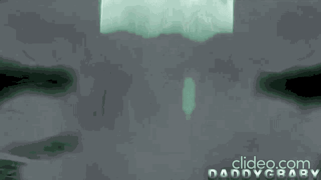 a man in a white coat is standing in a foggy area with the words clideo.com daddybaby written below him
