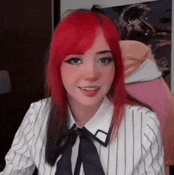 a girl with red hair is wearing a striped shirt and a tie .