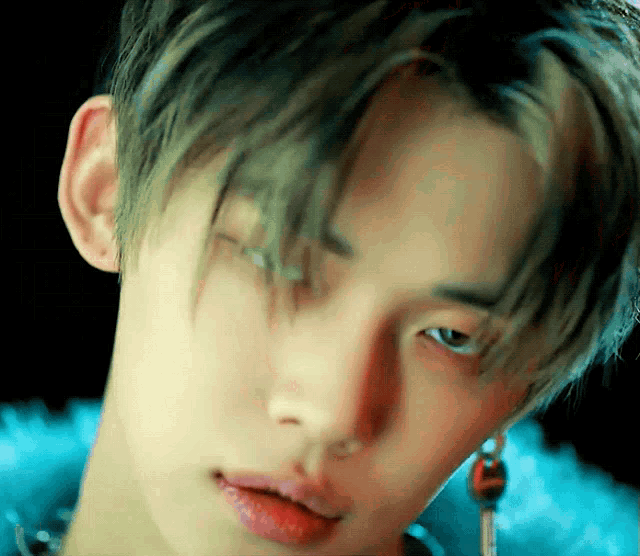 a close up of a young man 's face with a piercing in his ear
