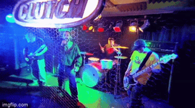 a group of people playing instruments in front of a clutch sign