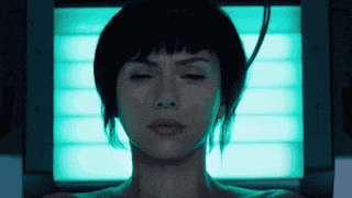 a close up of a woman 's face with a blue light behind her