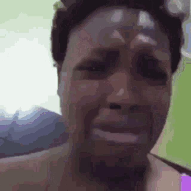 a close up of a person 's face with a tear running down their face .