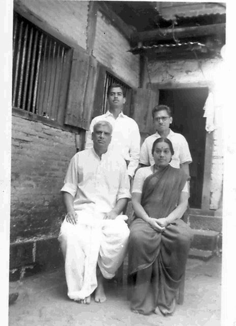 a group of people are posing for a photo in front of a building