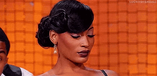 a woman in a dress is making a funny face and saying hoes .