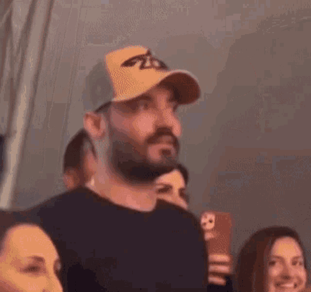 a man with a beard wearing a hat with the letter z on it