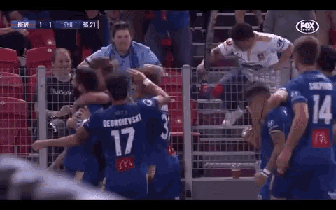 a group of soccer players are celebrating a goal and one of them has the number 17 on his back