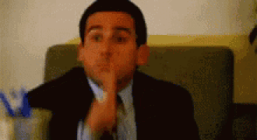 a man in a suit and tie is sitting on a couch .