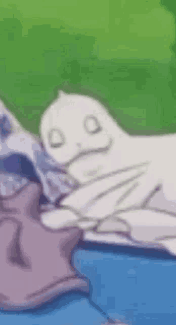 a seal is laying on top of a pile of clothes on a blue surface .