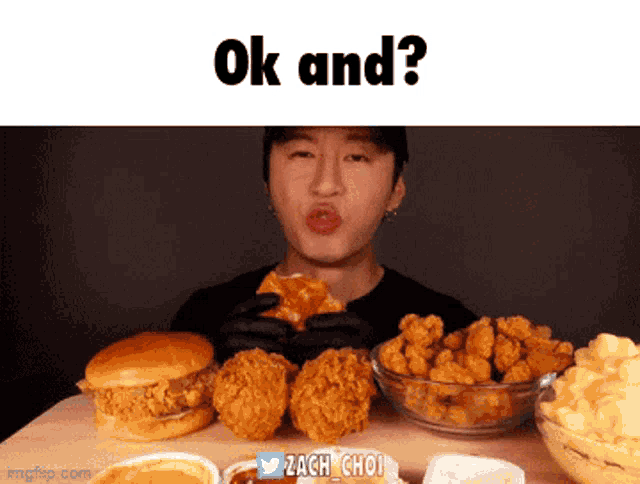 a man is sitting at a table eating fried chicken and a hamburger with the words " ok and " written above him
