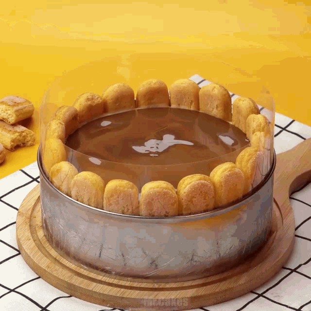 a cake on a wooden cutting board with the word cakes on the bottom