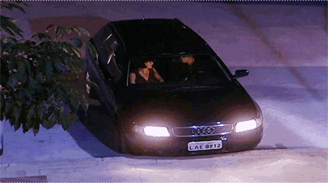 a black car with the license plate lae 8912