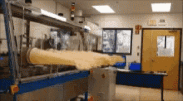 a blurred image of a room with a yellow door and a machine
