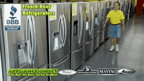 a man in a yellow shirt is standing in front of a row of refrigerators