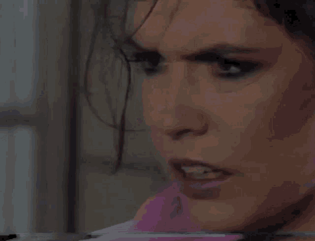 a close up of a woman 's face with her mouth open
