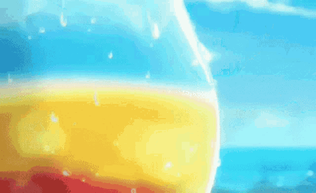 a close up of a person drinking a pineapple juice through a straw