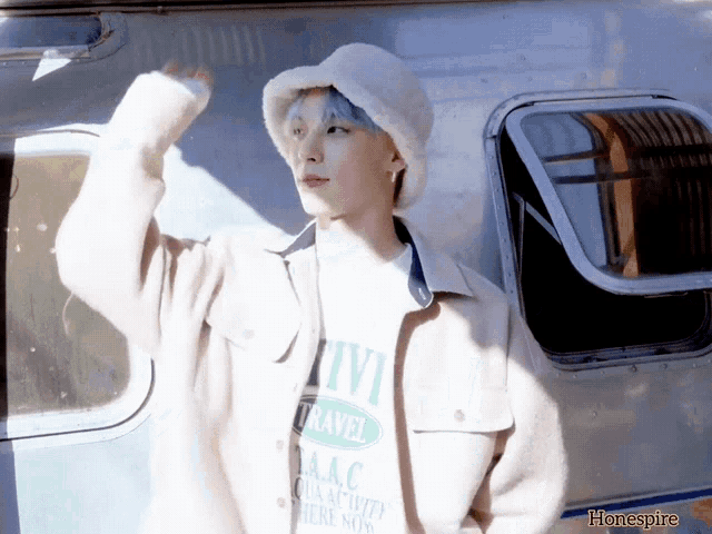 a person wearing a white hat and a t-shirt that says travel