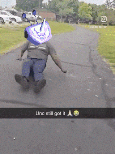 a man is sliding down a road with the words unc still got it below him