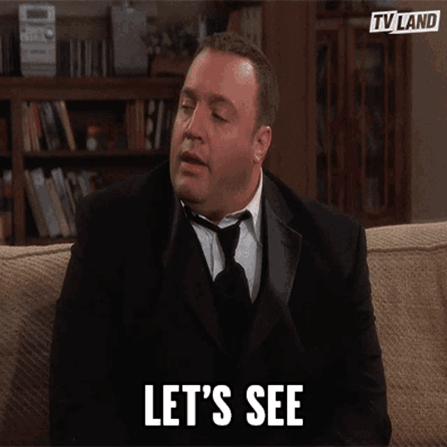 a man in a suit and tie is sitting on a couch with the words let 's see written below him