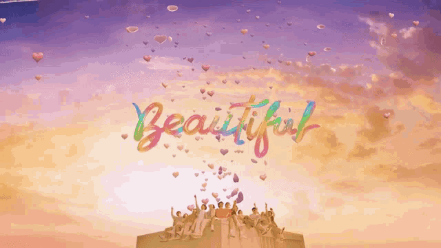 a group of people sitting on top of a building with the word beautiful written in rainbow colors