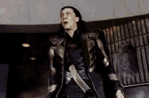 loki from avengers : age of ultron is standing in a room with his mouth open .
