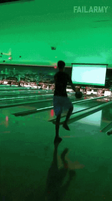 a man is throwing a bowling ball in a bowling alley with failarmy written on the bottom of the screen