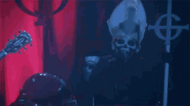 a skeleton is playing a guitar in front of a cross