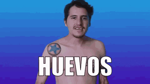 a shirtless man with a tattoo on his shoulder and the word huevos in white letters