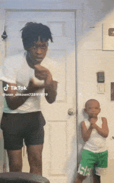 a man and a boy are standing in front of a door with tiktok written on it