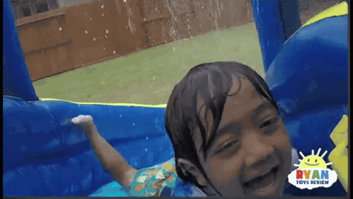 a child is playing in a bouncy house sponsored by ryan toys