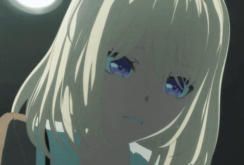 a girl with blonde hair and blue eyes is looking down
