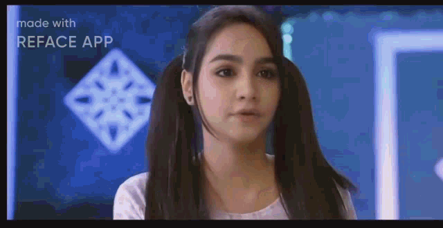 a girl with pigtails is looking at the camera .