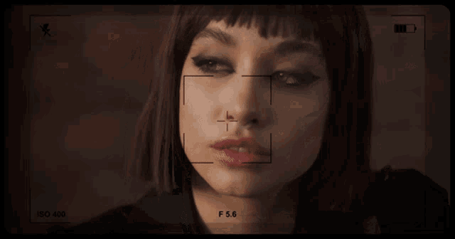 a close up of a woman 's face is being recorded at iso 450