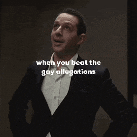 a man in a suit is dancing with the words when you beat the gay allegations below him