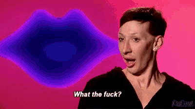 a woman is making a funny face in front of a purple lips and says `` what the fuck '' .