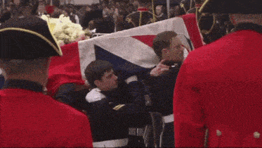 a man in a military uniform is carrying a flag