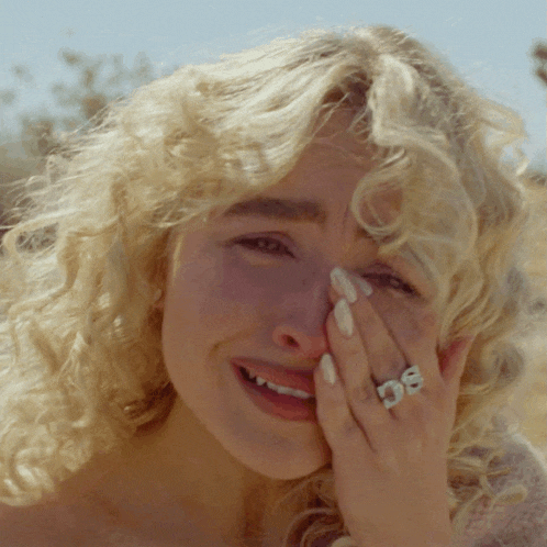 a woman with a ring on her finger that says ' sg '