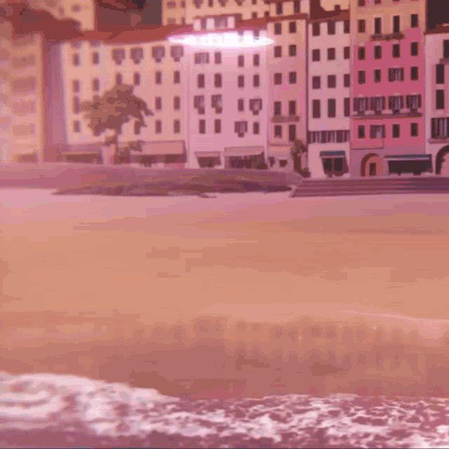 a beach with buildings in the background and a pink light coming from the sky