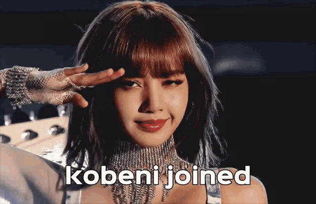 a woman wearing a necklace and gloves with the words kobeni joined