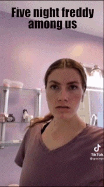 a woman is standing in front of a purple wall with the words five night freddy among us written on it