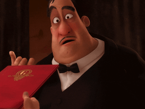 a man in a tuxedo and bow tie is holding a red book with a g on it