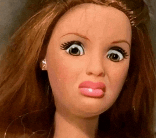 a close up of a barbie doll with a funny face
